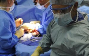 Performing a rare microscopic surgical procedure for a tumor in the skull.